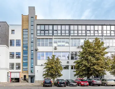 an office building with cars parked in front of it at Modern Urban loft in Vilnius