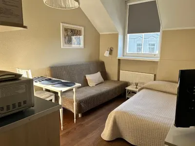 a small living room with a couch and a table at Gedimino House in Vilnius