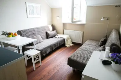 a living room with a couch and a table at Gedimino House in Vilnius