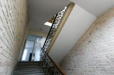 a staircase in a building with a glass door at Gedimino House in Vilnius