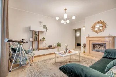 a living room with a couch and a fireplace at LuxCosy72m SelfCheckIn Huge2roms 9minOTown FreeParking in Vilnius