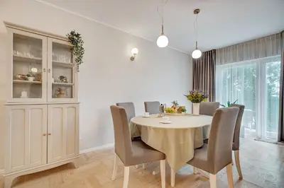 a dining room with a table and chairs at LuxCosy72m SelfCheckIn Huge2roms 9minOTown FreeParking in Vilnius