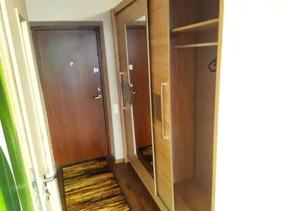 a hallway with a glass door and a closet at ITAJA apartment 66 in Šiauliai