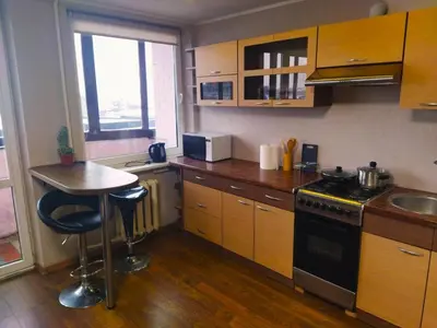 a kitchen with a table and a stove top oven at ITAJA apartment 66 in Šiauliai