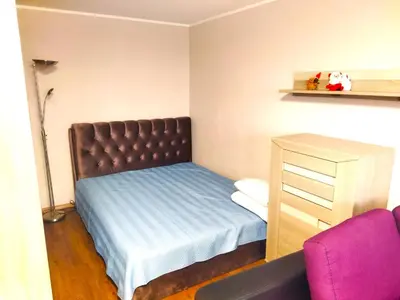 a small bedroom with a bed and a dresser at ITAJA apartment 66 in Šiauliai