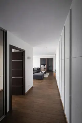 a hallway leading to a living room with a couch at Downtown Boulevard View Residence in Šiauliai