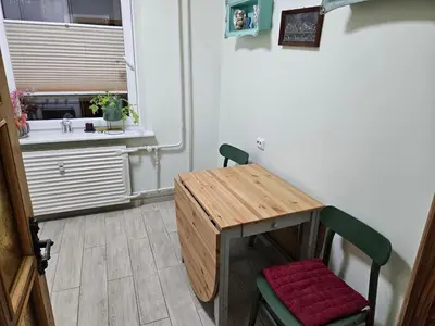 a small table and a chair in a room at HOME20GEDV in Vilnius