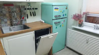 a blue refrigerator in a kitchen with a sink at HOME20GEDV in Vilnius