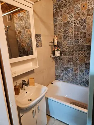 a bathroom with a sink and a bath tub and a sink at HOME20GEDV in Vilnius