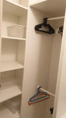 a walk in closet with white shelves at HOME20GEDV in Vilnius