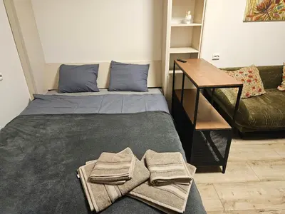 a bedroom with a bed with towels on it at HOME20GEDV in Vilnius