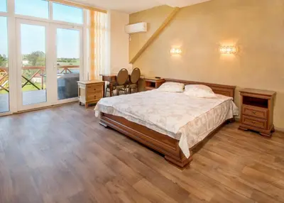 a bedroom with a bed and a large window at Sodyba ant ežero kranto pas Radvilą in Kiemeliai