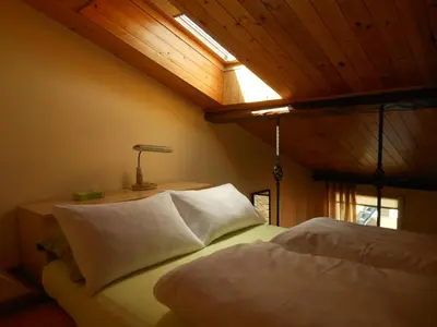 a bedroom with a bed with a light on the ceiling at Daukanto Apartments in Vilnius