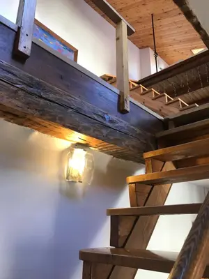 a loft bed with a light on the wall at Daukanto Apartments in Vilnius