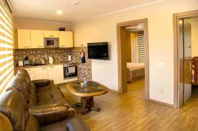 a living room with a couch and a table at NK apartments in Druskininkai