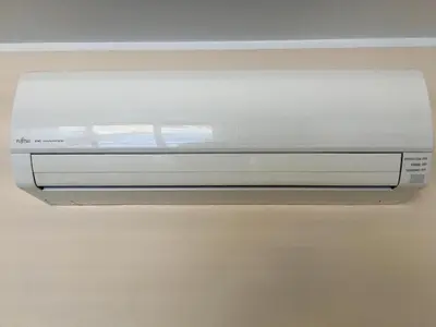 a white object is hanging from a ceiling at NK apartments in Druskininkai