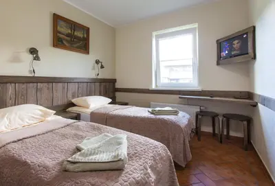 a hotel room with two beds and a window at Sodyba Ignė in Druskininkai