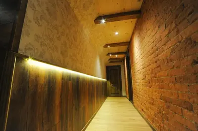 an empty hallway with a brick wall and a corridorngthngthngthngthngthngth at Karčema Ružava in Molainiai