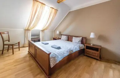 a bedroom with a bed and a chair and a window at Central apartments 3 x Free parking x SELF CHECK-IN in Vilnius