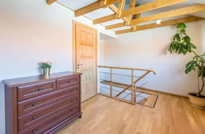 a room with a wooden dresser and a wooden staircase at Central apartments 3 x Free parking x SELF CHECK-IN in Vilnius