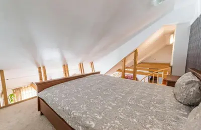 a bedroom with a bed and a staircase at Central apartments 3 x Free parking x SELF CHECK-IN in Vilnius