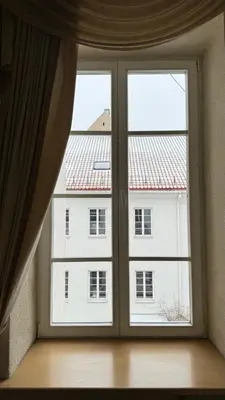 a window with a view of a white building at Central apartments 3 x Free parking x SELF CHECK-IN in Vilnius