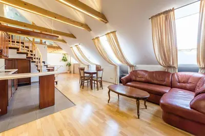 a living room with a leather couch and a table at Central apartments 3 x Free parking x SELF CHECK-IN in Vilnius