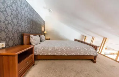 a bedroom with a bed and a dresser and a staircase at Central apartments 3 x Free parking x SELF CHECK-IN in Vilnius