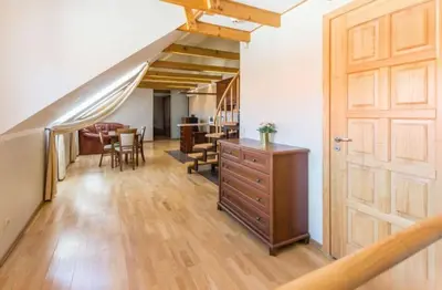 a room with a wooden door and a dining room at Central apartments 3 x Free parking x SELF CHECK-IN in Vilnius