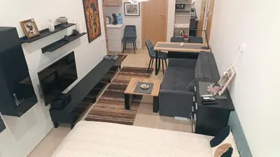 a living room with a couch and a table at L studio in Kaunas