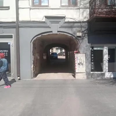 a person walking through a tunnel in a building at L studio in Kaunas