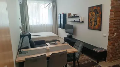 a room with a dining table and a bed at L studio in Kaunas