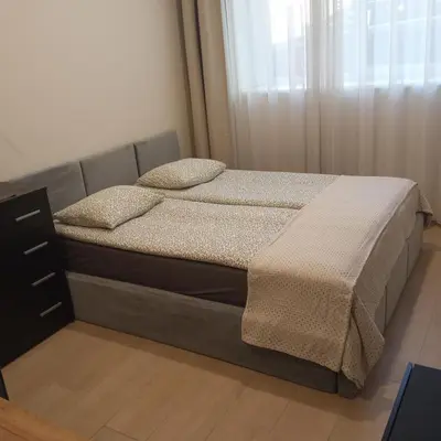 a bedroom with a bed and a dresser at L studio in Kaunas