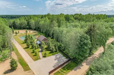 an aerial view of a house in a forest at Zalesossodyba in Purnuškis