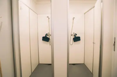 a row of white lockers in a locker room at Natur Camp Birštonas Small Cabins in Birštonas