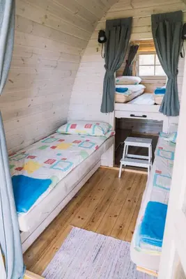 a room with two beds and a desk at Natur Camp Birštonas Small Cabins in Birštonas