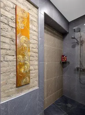 a bathroom with a shower and a painting on the wall at HaPPy iNN ToTo Old Town, Self check, Parking in the yard, in Vilnius