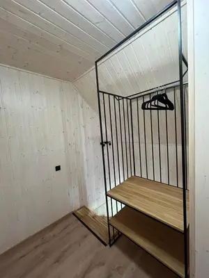 an empty room with a cage in a room at Namelis ant ežero kranto 