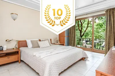 a bedroom with a bed and a sign that says top at Jacuzzi apartments x Free parking x SELF CHECK-IN 24x7 by H&H in Vilnius