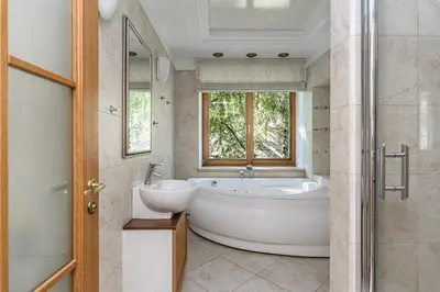 a bathroom with a tub and a sink and a window at Jacuzzi apartments x Free parking x SELF CHECK-IN 24x7 by H&H in Vilnius