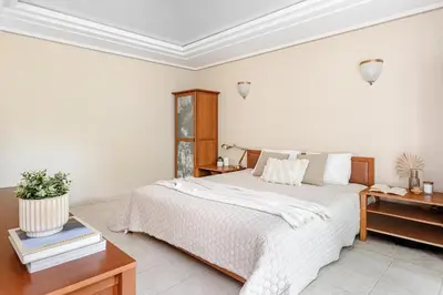 a bedroom with a large white bed and a desk at Jacuzzi apartments x Free parking x SELF CHECK-IN 24x7 by H&H in Vilnius