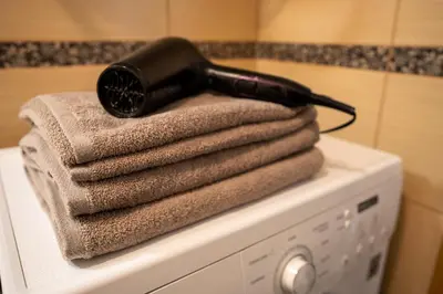 a hair dryer sitting on top of a washing machine at Loft apartment in Druskininkai