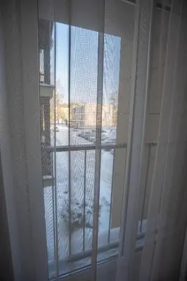 a window with a view of a snow covered street at Loft apartment in Druskininkai