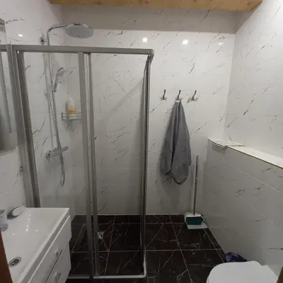 a bathroom with a shower and a toilet and a sink at S Neries 19 apartamentai su parkingu in Šiauliai