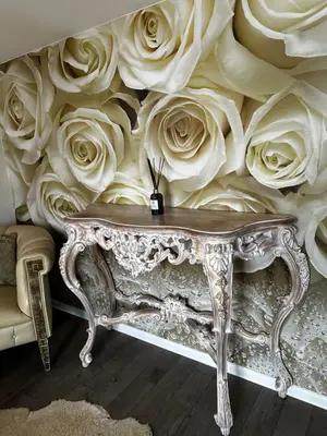 a room with a wall covered in white roses at Cosy apartment in Kaunas