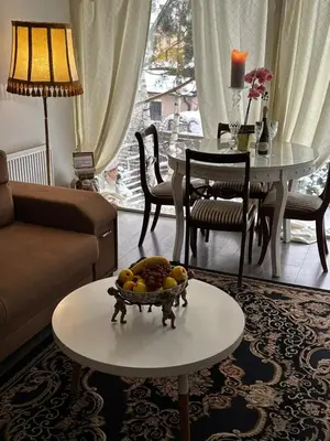 a living room with a bowl of fruit on a table at Cosy apartment in Kaunas