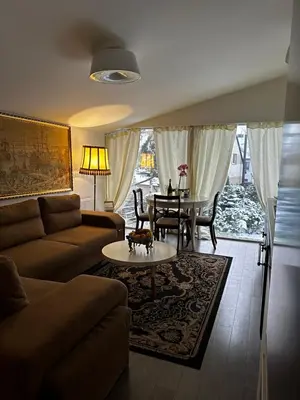 a living room with a couch and a table at Cosy apartment in Kaunas