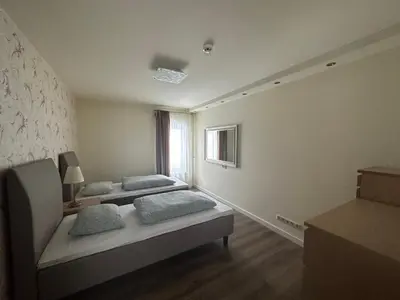 a room with two beds and a window at Apartamentai in Marijampolė