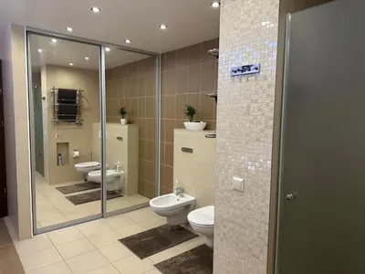 a bathroom with two toilets and a shower at Apartamentai in Marijampolė