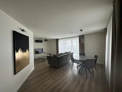 a living room with a table and a couch at Apartamentai in Marijampolė